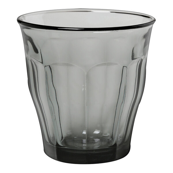 A clear Duralex glass tumbler with a black rim.