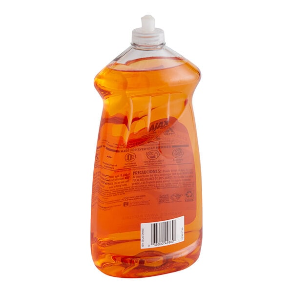 A plastic bottle of orange liquid dish detergent.