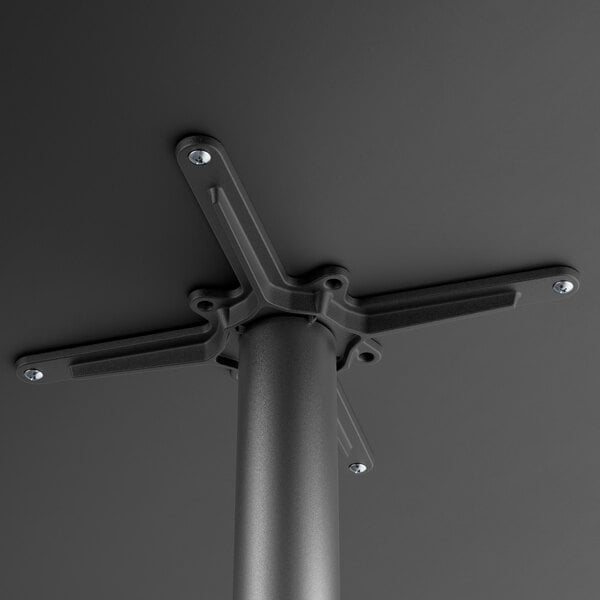 A Lancaster Table & Seating black metal table base with a metal pole.