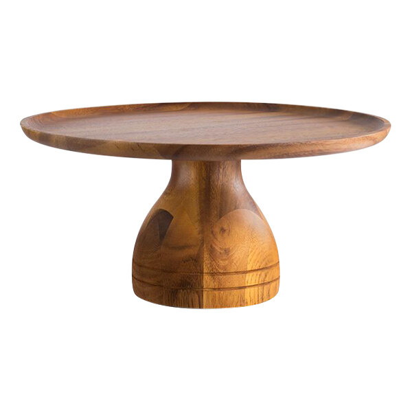 An APS round wooden cake stand with a round wooden surface.