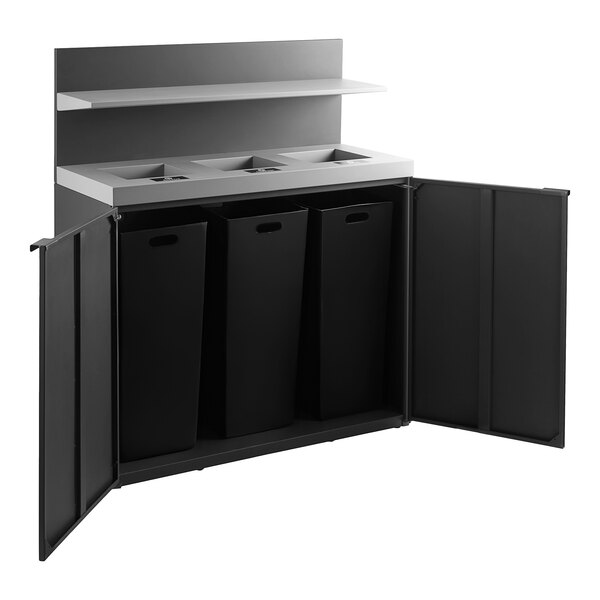 A black rectangular Lancaster Table & Seating waste receptacle with three bins inside.