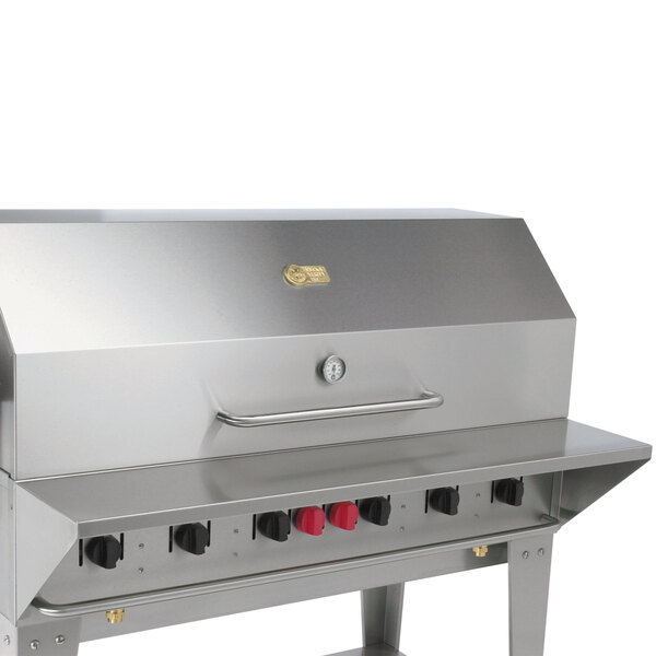 A stainless steel barbecue grill with a removable front shelf.
