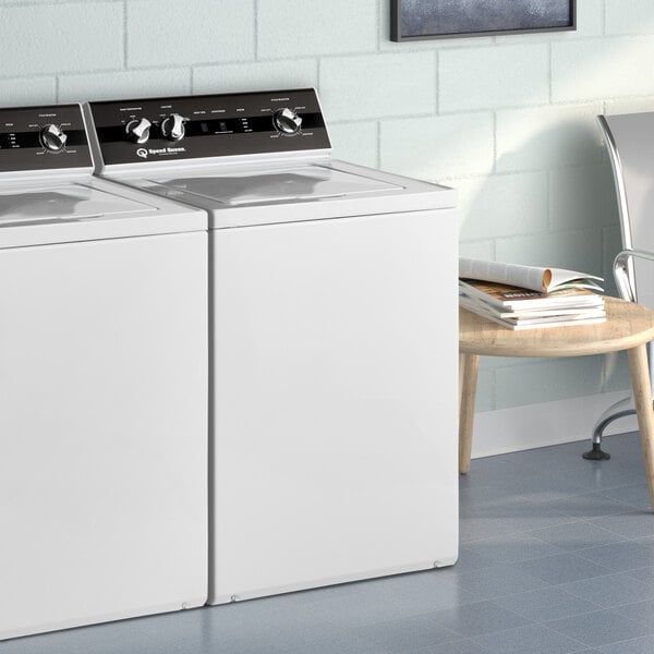 A white Speed Queen top load washer in a room with a white background.