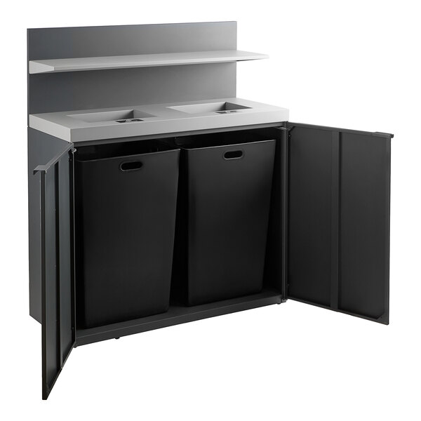 A Lancaster Table & Seating dark gray steel rectangular waste receptacle with two black bins inside.