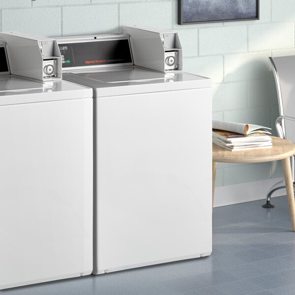 A white Speed Queen top load commercial washer.