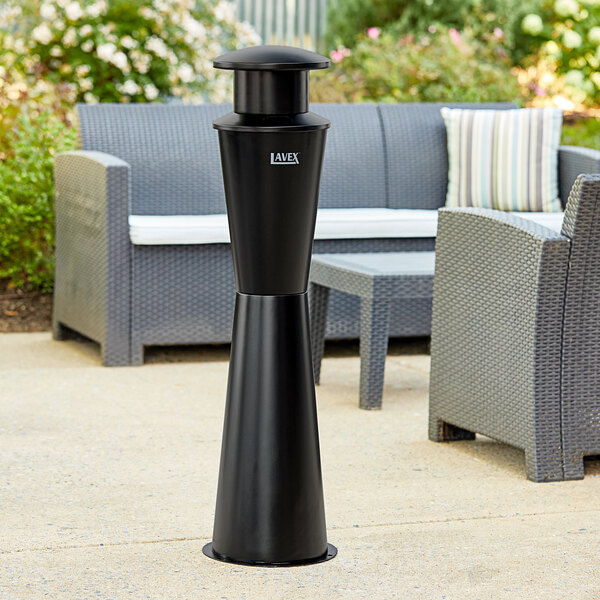 A black Lavex steel freestanding cigarette receptacle on an outdoor patio table.