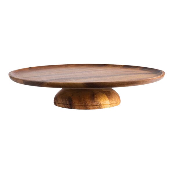An APS round acacia cake stand with a wood surface on a wooden base.
