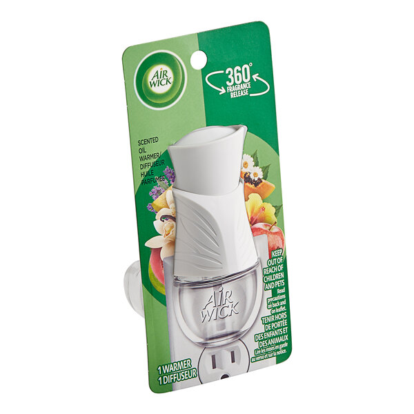 An Air Wick scented oil warmer in white and clear packaging with a green leaf on it.