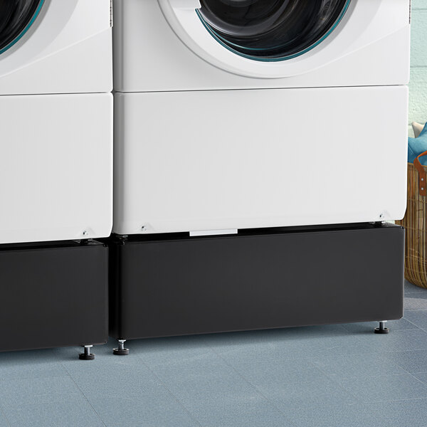 A black Speed Queen pedestal next to a white Speed Queen washing machine.