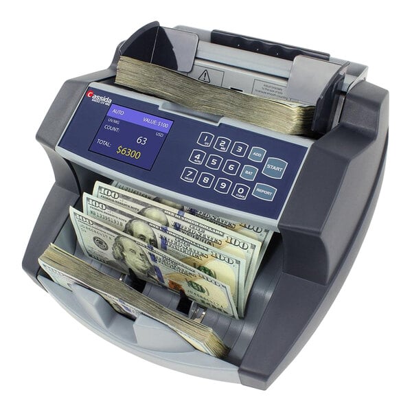 A Cassida 6600 money counting machine counting cash.