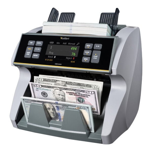 A Kolibri mixed denomination bill counting machine with two bills being counted.