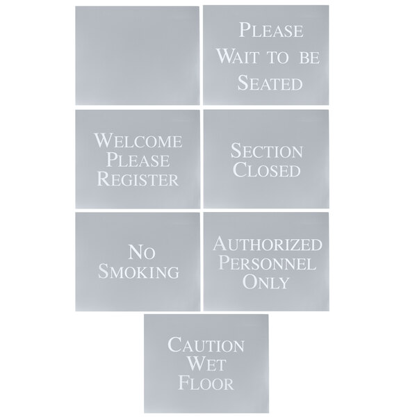 A group of grey Aarco hostess signs with white text.