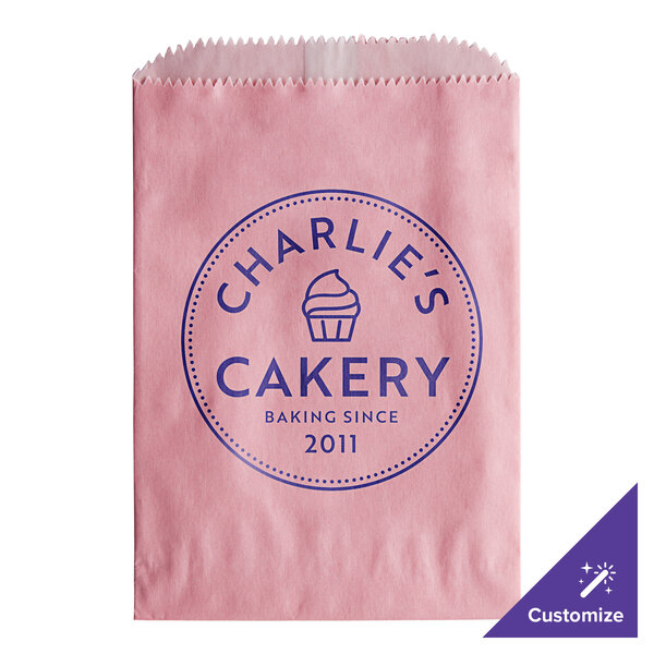 A customizable pink paper bag with blue text that reads "Charlie's Bakery"