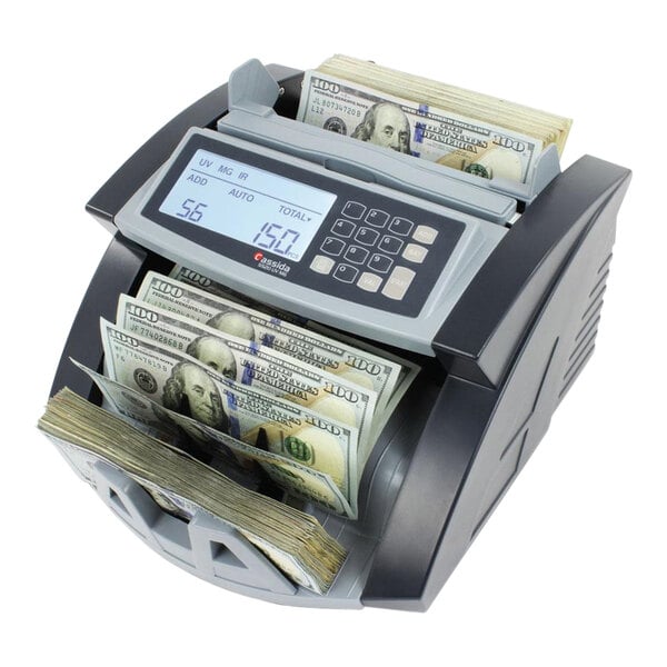 A Cassida 5520 bill counting machine with a digital display counting cash.