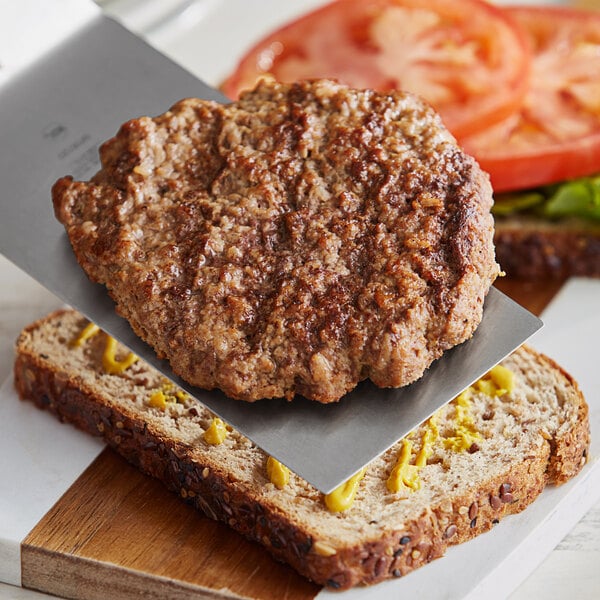 An AdvancePierre Pub Burger Patty on a cutting board.