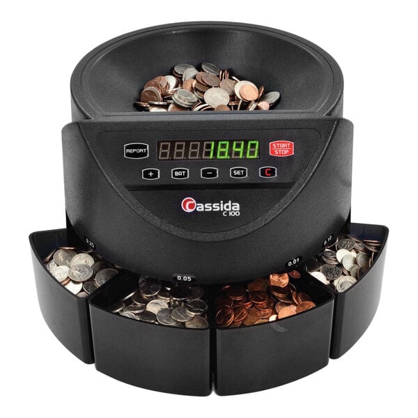 A black Cassida C-C100 coin counting machine on a counter with a number of coins displayed.