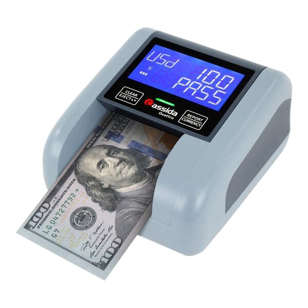 A Cassida Quattro 4-Way Counterfeit Detector on a counter with a digital display.
