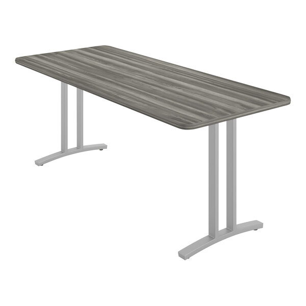 A Correll rectangular table with metal legs and a grey wood surface.