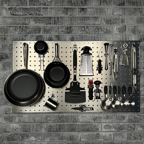 A metal Triton LocBoard holding various kitchen utensils and pans.