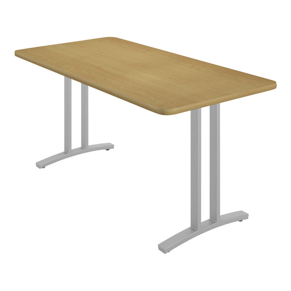 A Correll rectangular table with metal legs and a Fusion Maple finish.