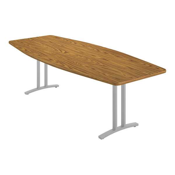 A Correll medium oak laminate conference table with metal legs.