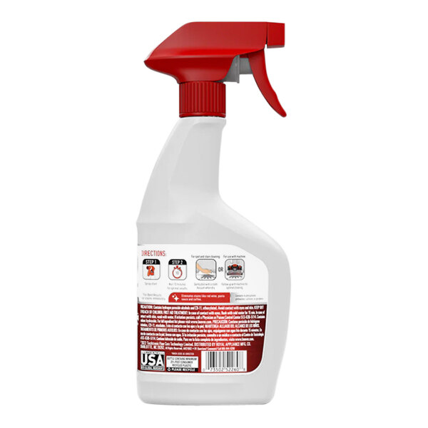 A close-up of a white and red Hoover Oxy Spot and Stain Remover spray bottle.
