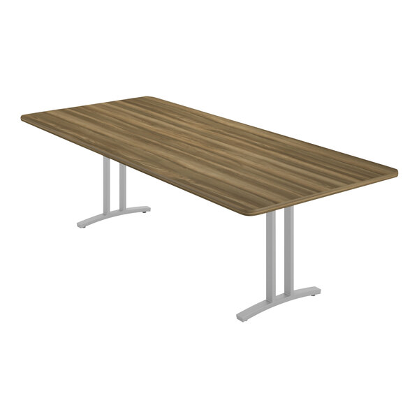 A Correll rectangular conference table with a Colonial Hickory finish and metal base.