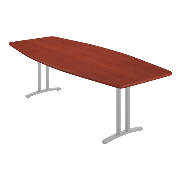 A Correll boat-shaped cherry wood conference table with metal legs.