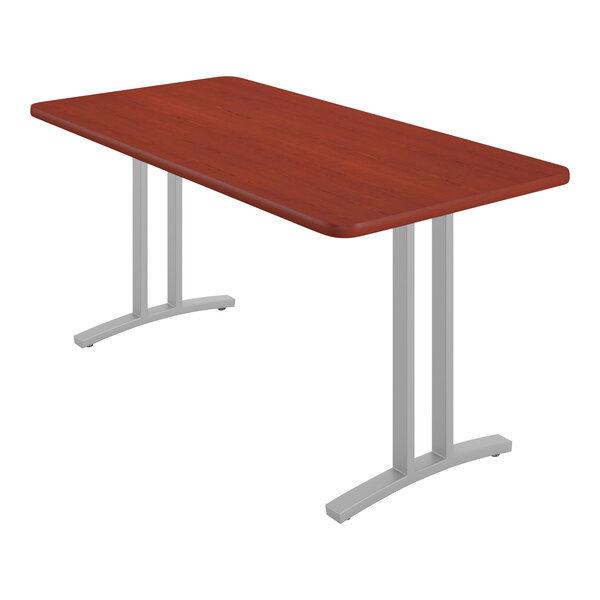 A rectangular Correll table with metal legs and a cherry wood surface.