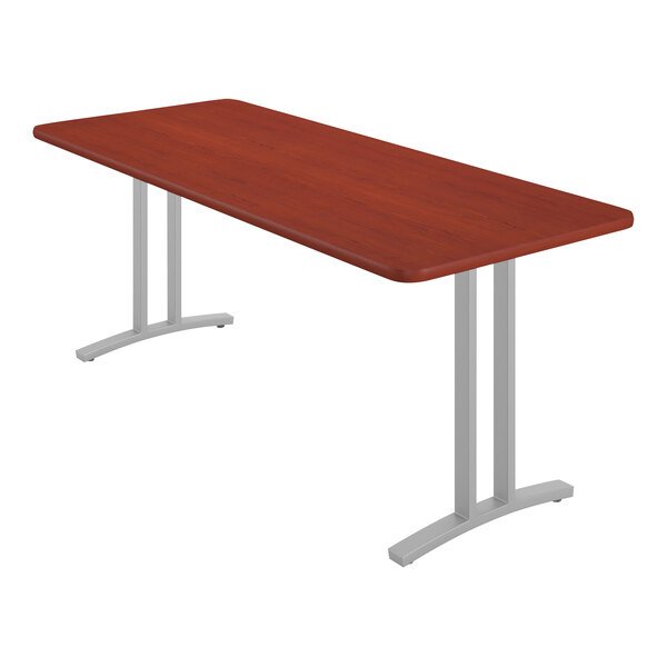 A rectangular Correll table with metal legs and a cherry wood finish.