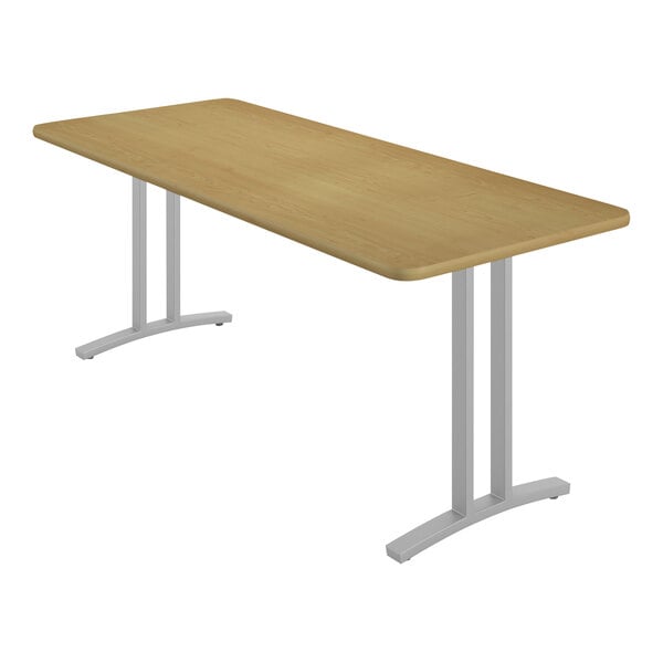 A Correll rectangular table with metal legs and a fusion maple finish.