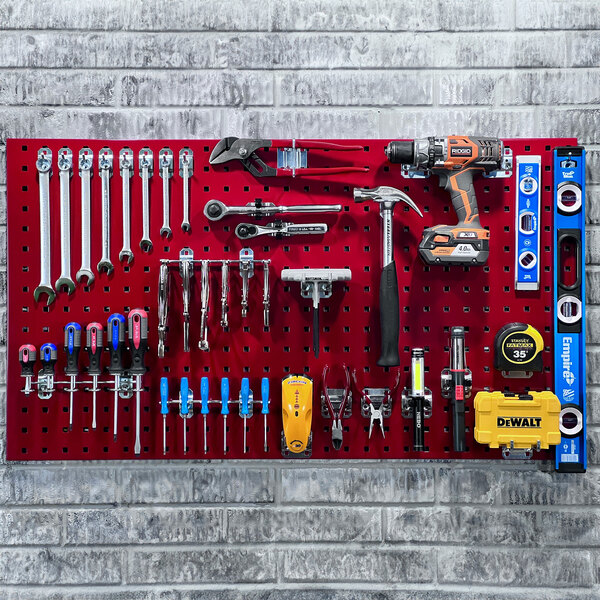 A red Triton LocBoard with tools hanging on it.