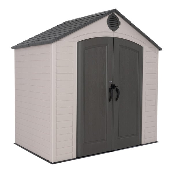 A Lifetime outdoor storage shed with a grey door and black handles.