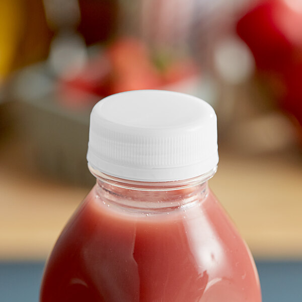 A Clear Tamper-Evident Cap on a bottle of pink liquid.