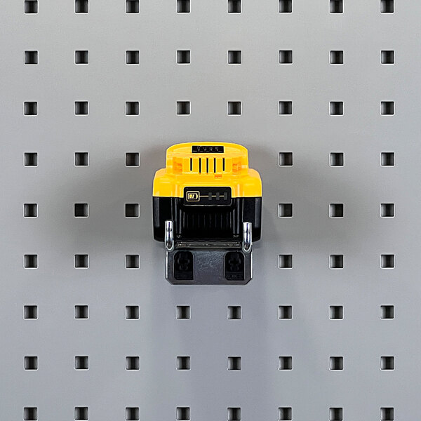 A yellow and black toy truck on a grey peg board with a Triton Products LocHook double rod.