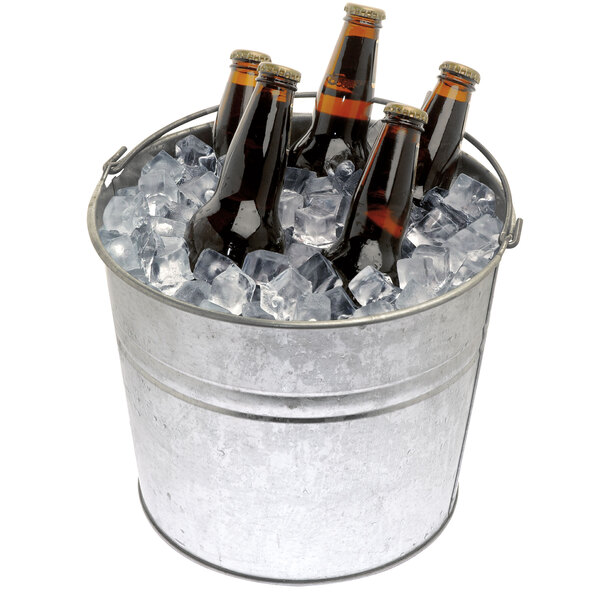 A Manitowoc hotel ice dispenser with a bucket of beer bottles in ice.