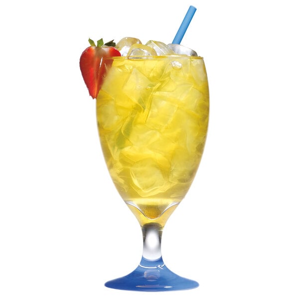 A glass of lemonade with a straw and a strawberry in front of a Manitowoc ice dispenser.