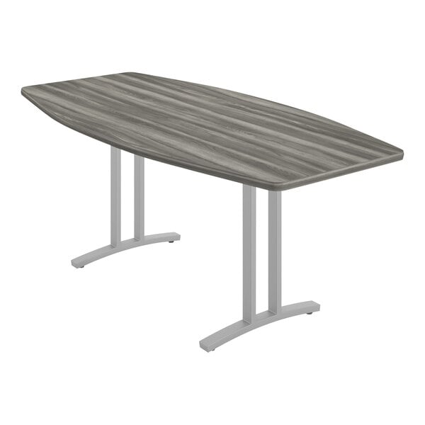 A Correll New England driftwood laminate conference table with curved ends and metal legs.