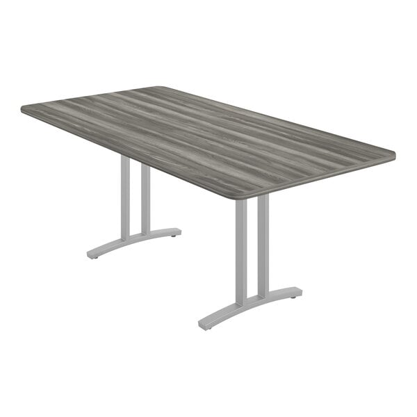 A Correll rectangular conference table with a New England driftwood finish on a metal base.