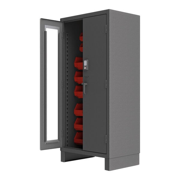 A grey metal cabinet with red bins.