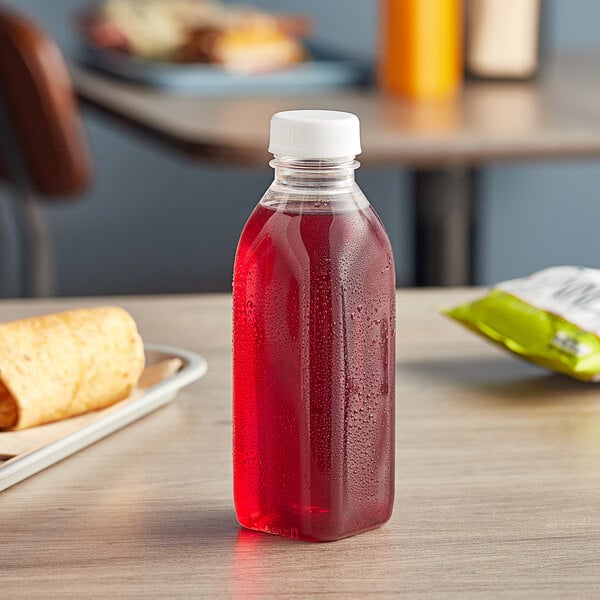 A 16 oz. Square Milkman PET clear juice bottle with red liquid in it.