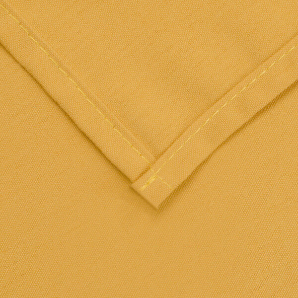 A close up of a yellow rectangular table cover with a hemmed edge.