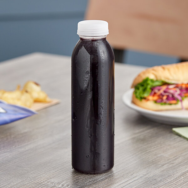 A clear plastic bottle with a white cap on a table.