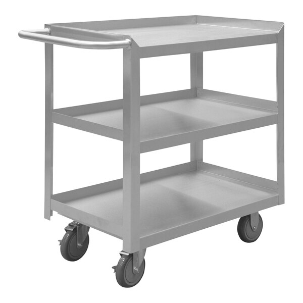 A silver metal cart with three shelves and wheels.