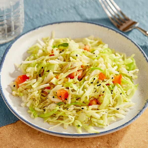 A plate of plain cabbage slaw with a fork.