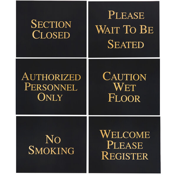 A group of four black Aarco hostess signs with gold text.