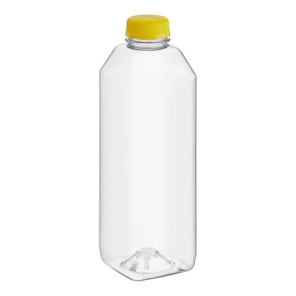 A clear plastic 32 oz. square juice bottle with a yellow cap.