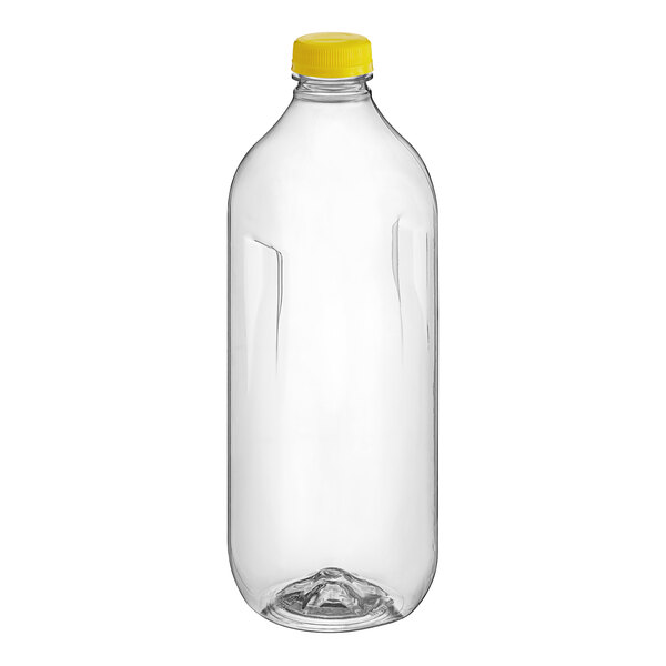 A clear plastic square juice bottle with a yellow cap.