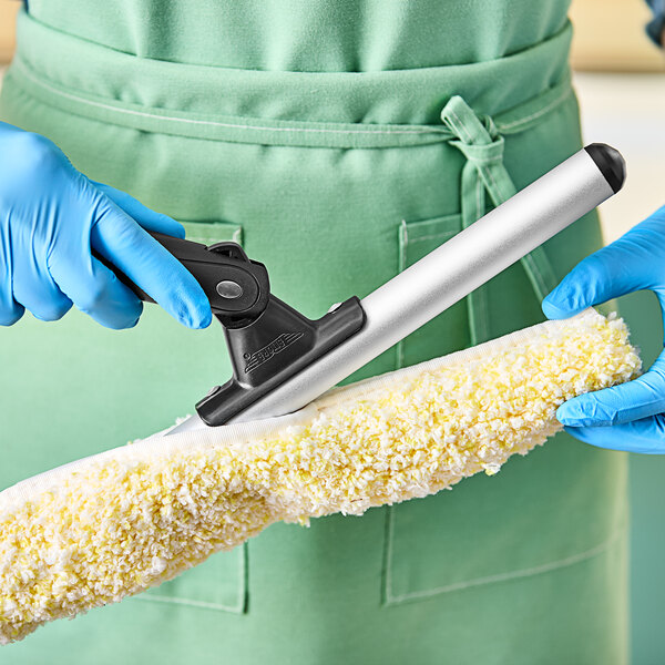 A gloved hand using an Ettore Pro+ 22" T-Bar Window Washer.