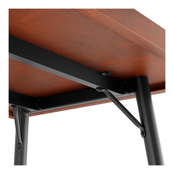 A Lancaster Table & Seating butcher block table with a metal frame.